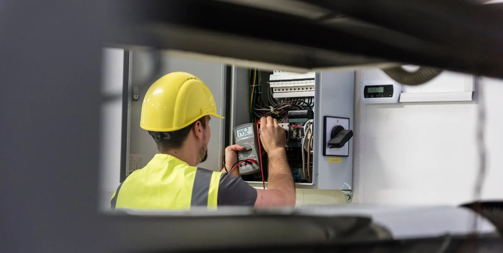Allegheny service electrician at a control panel