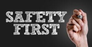 Hand writing the text: Safety First