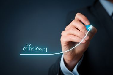 The hand of a business person is drawing a line with an upward climb next to the word EFFICIENCY